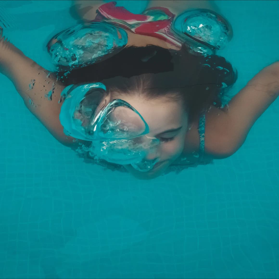 Child diving through pool